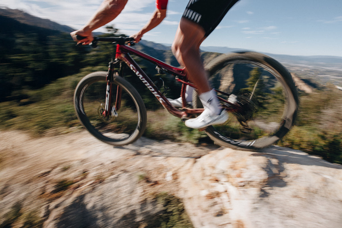 Rider on a Specialized Epic 9 on rocky singletrack